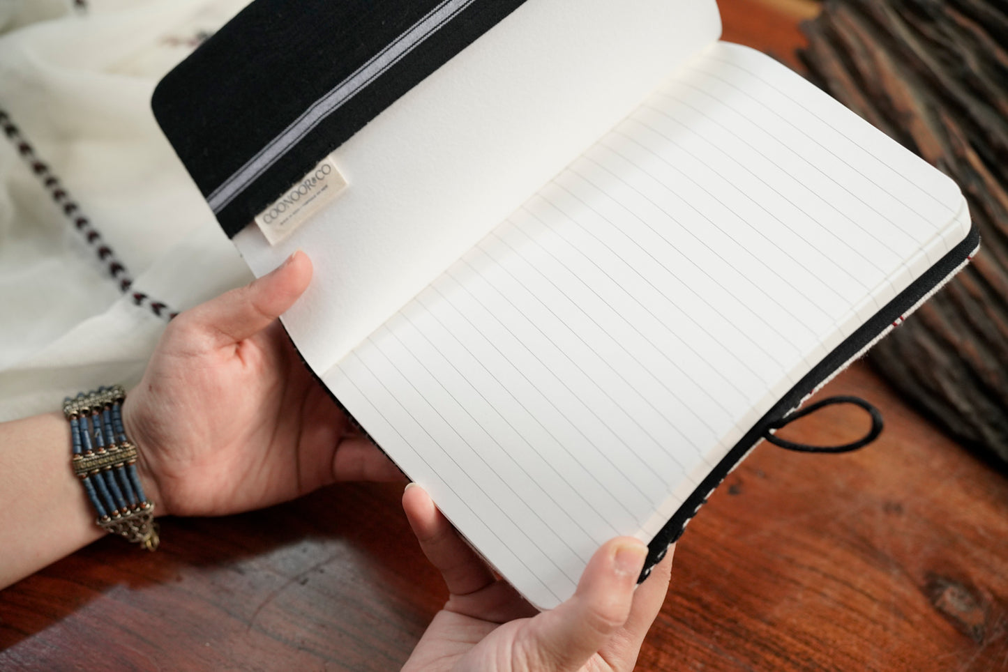 The Nilgiri Journal open showing A5 notebook and Toda embroidered sleeve together