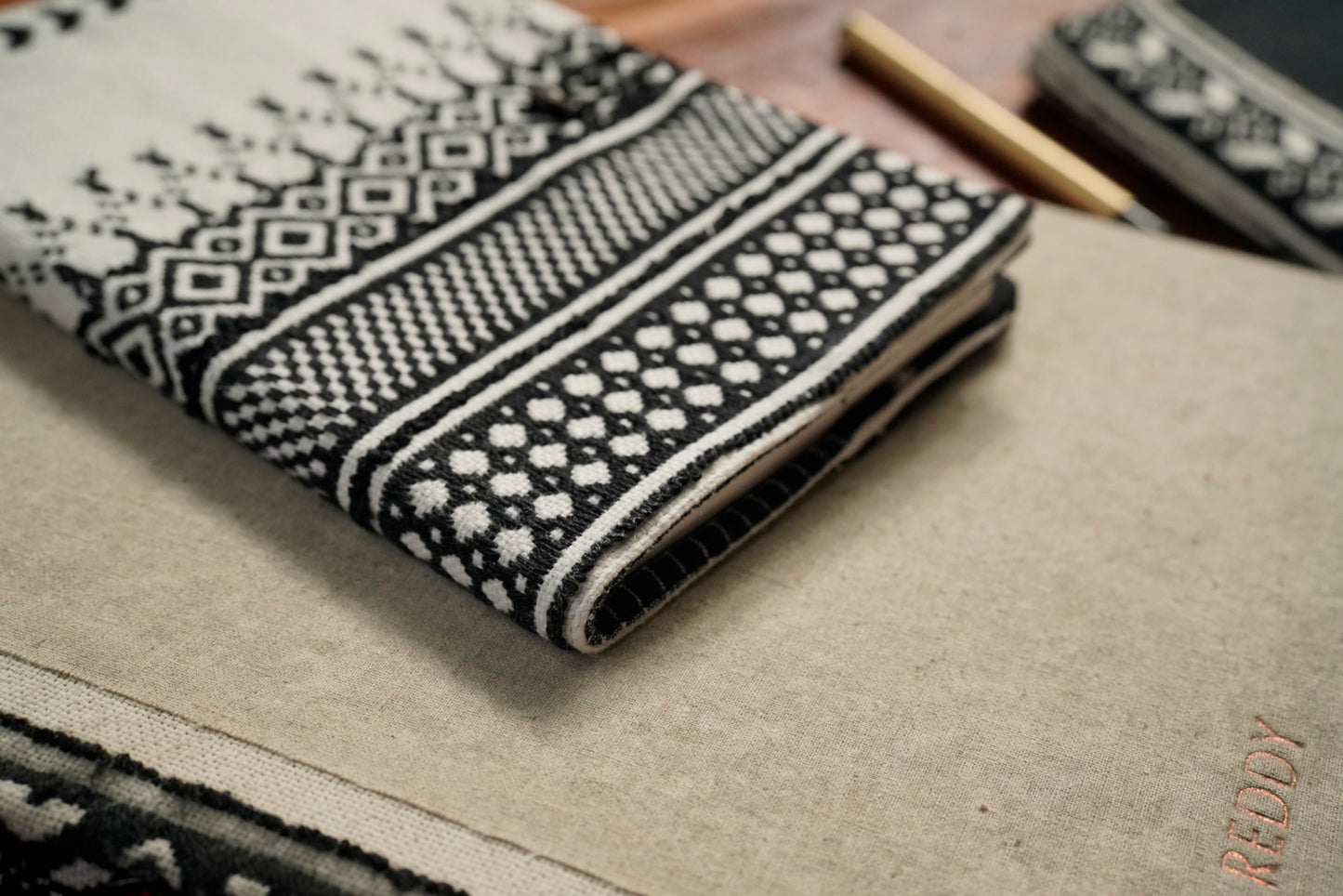 Black journal sleeve open showing A5 notebook pairing, luxury artisan gifting