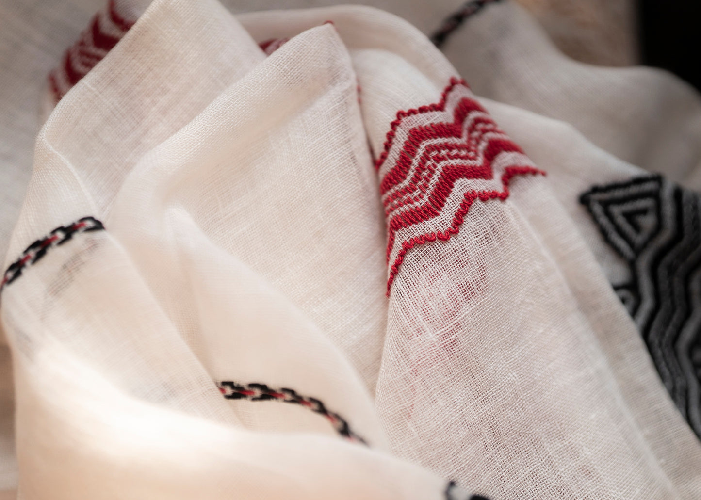 Full drape of Sacred Peaks linen stole showing light airy fabric and mountain motif borders