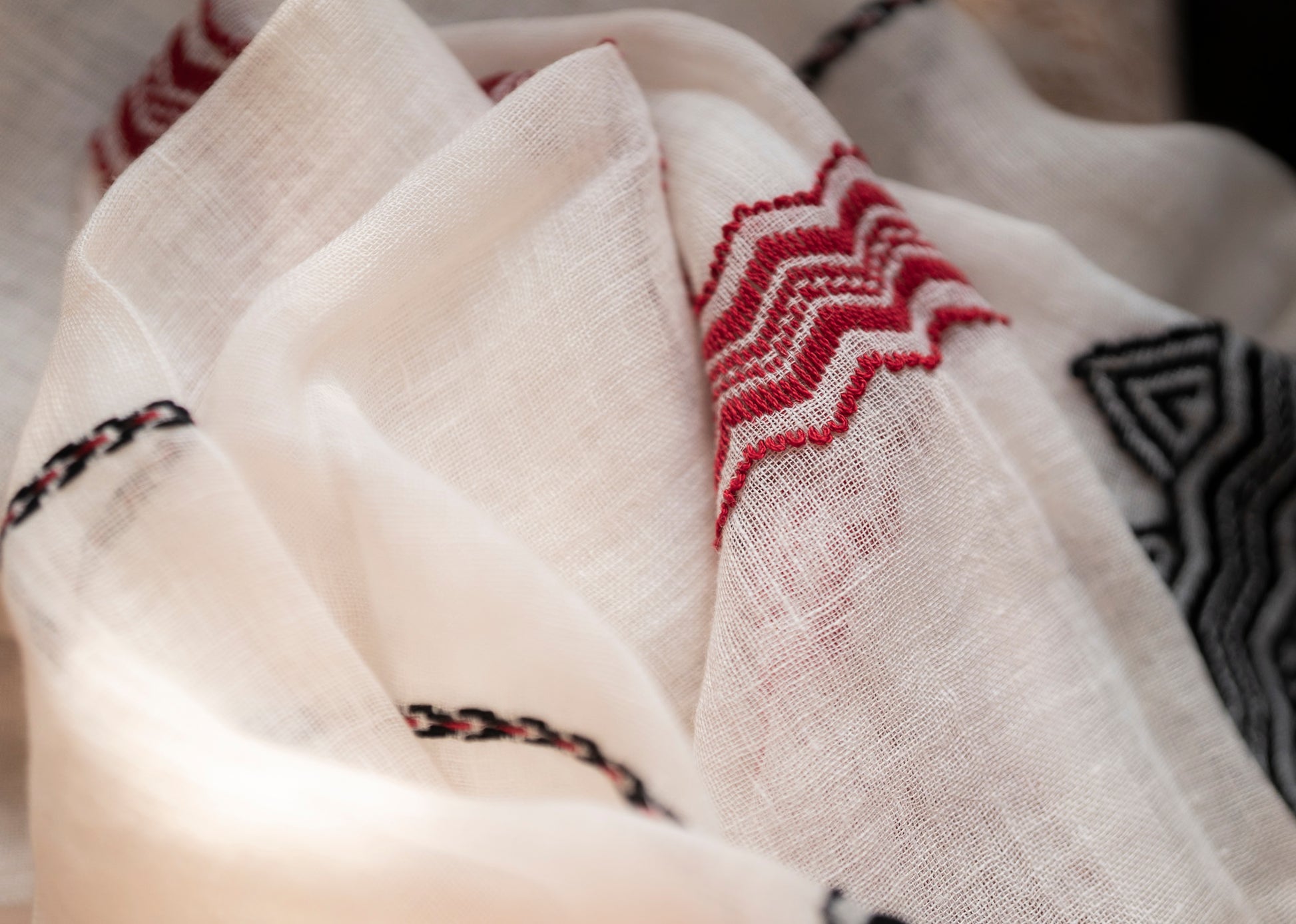 Full drape of Sacred Peaks linen stole showing light airy fabric and mountain motif borders
