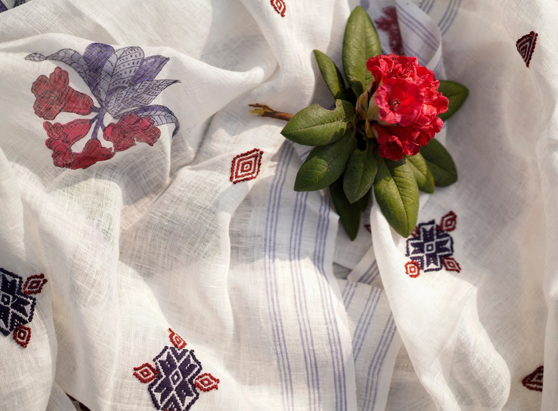 Rhododendron Stole 1, Jaipur block-printed rhododendron arboreum in crimson and navy with GI-tagged Toda embroidery on fine linen