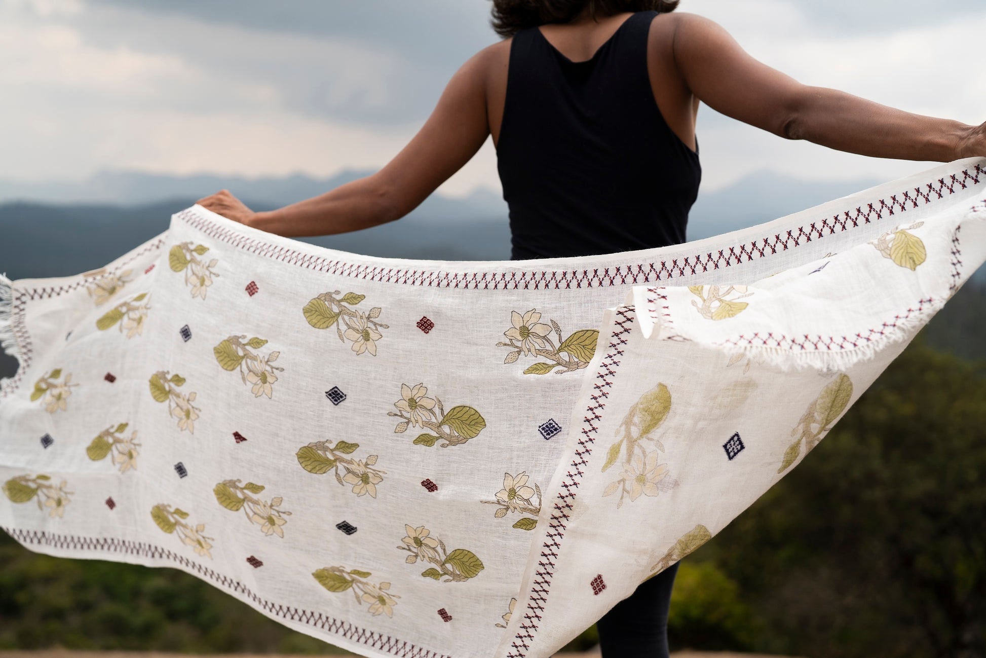 Full drape of Magnolia Stole 1 on fine linen showing magnolia motifs and Toda embroidery borders
