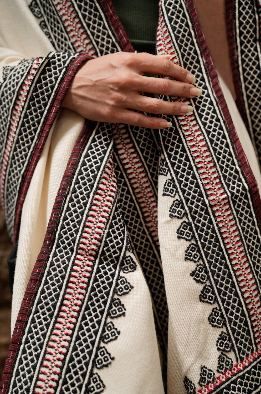 Detail of Toda pukhoor embroidery on Mishpuum Poof oversized Tencel shawl, mountain motifs