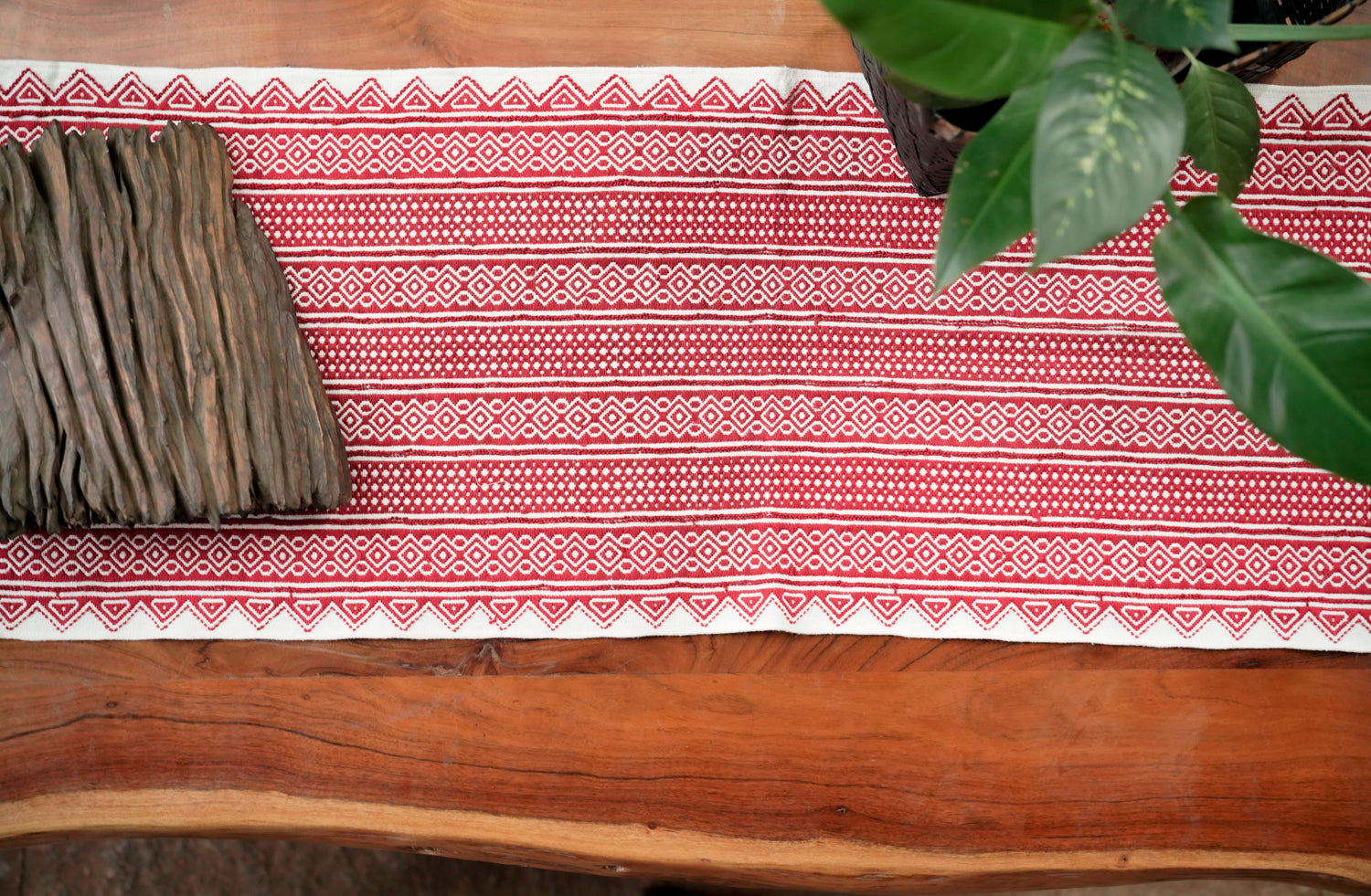 Classic Tapestry Rich Red styled as wall art showing bold red Toda embroidery