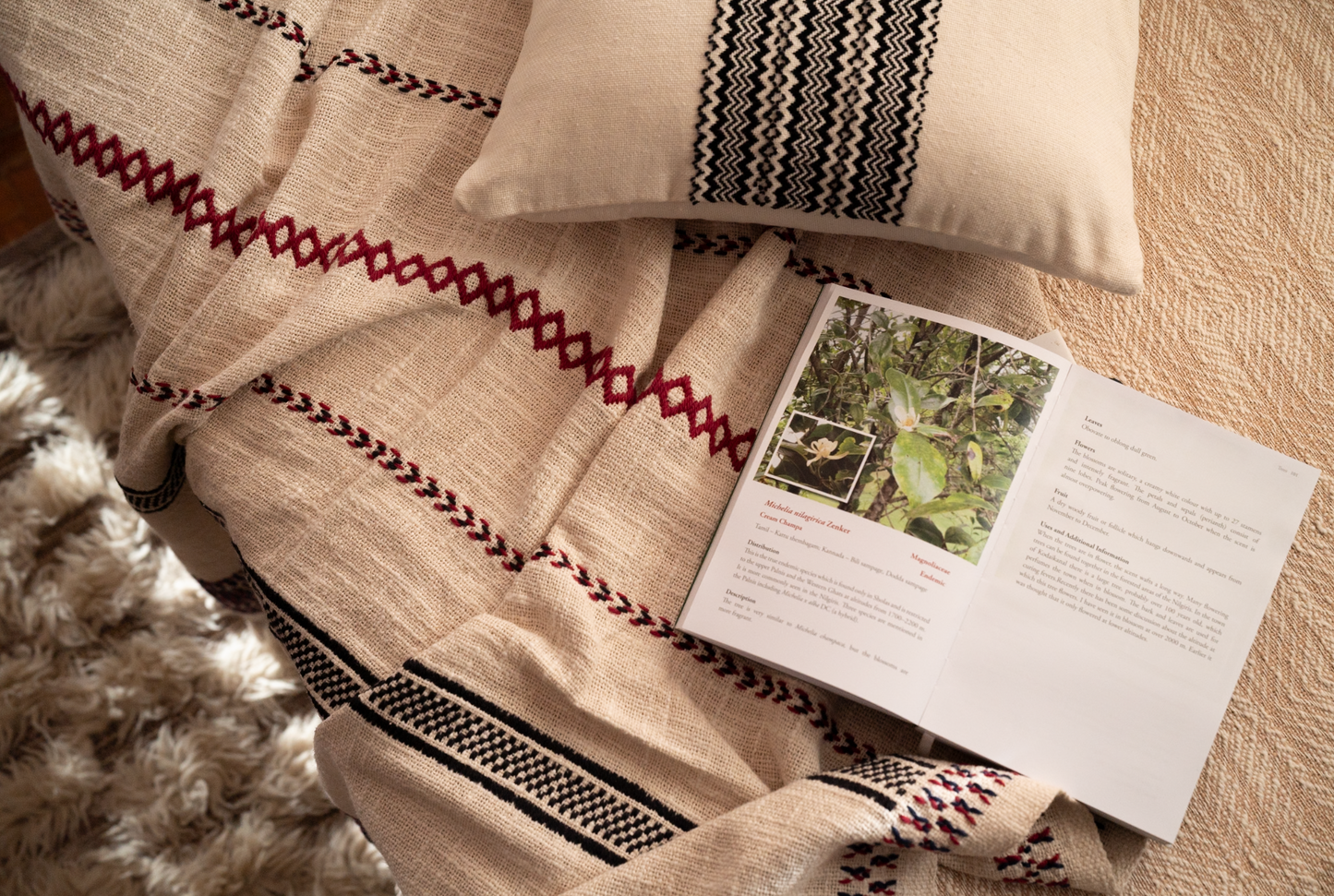 Stillness Throw on luxury interior setting showing meditative embroidery pattern across slub cotton