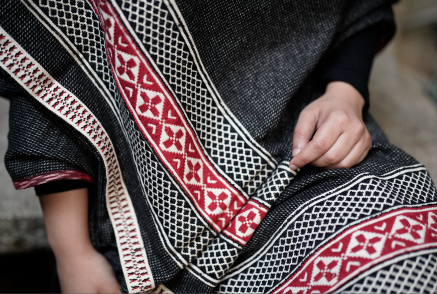 Detail of chevron Toda pukhoor embroidery in black and red on cotton-wool winter shawl