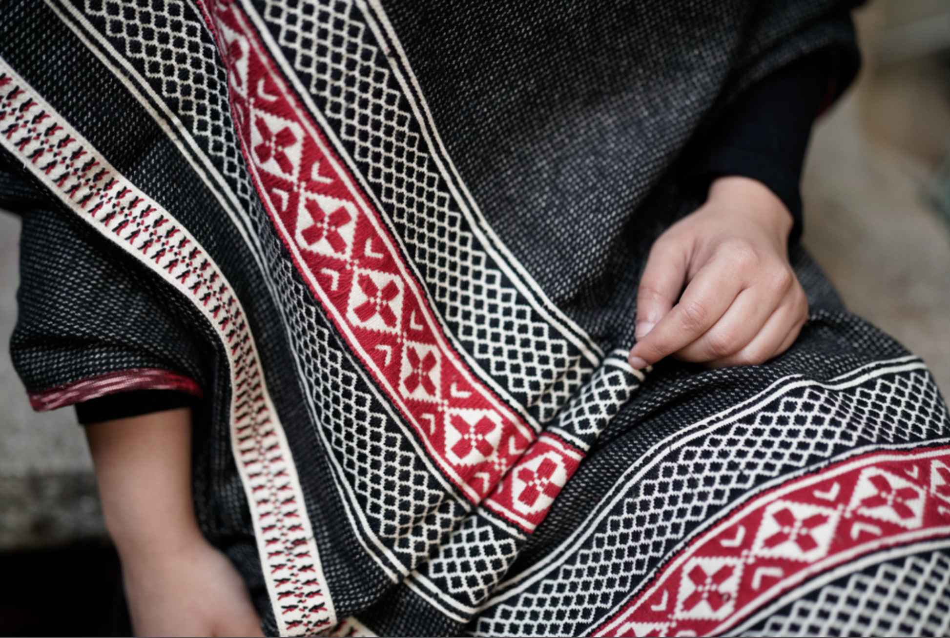 Detail of chevron Toda pukhoor embroidery in black and red on cotton-wool winter shawl