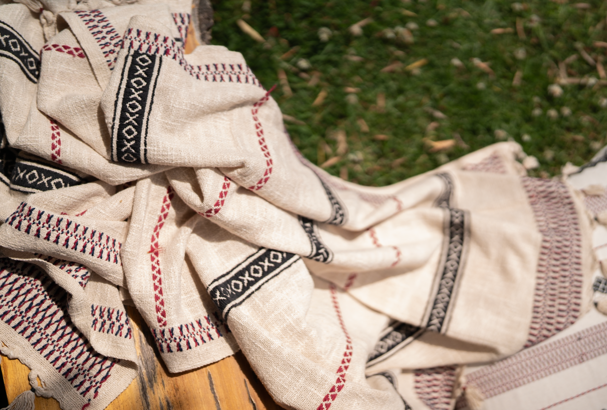 Detail of pukhoor Toda embroidery in wool yarn on slub cotton throw, ancient motifs, dimensional depth