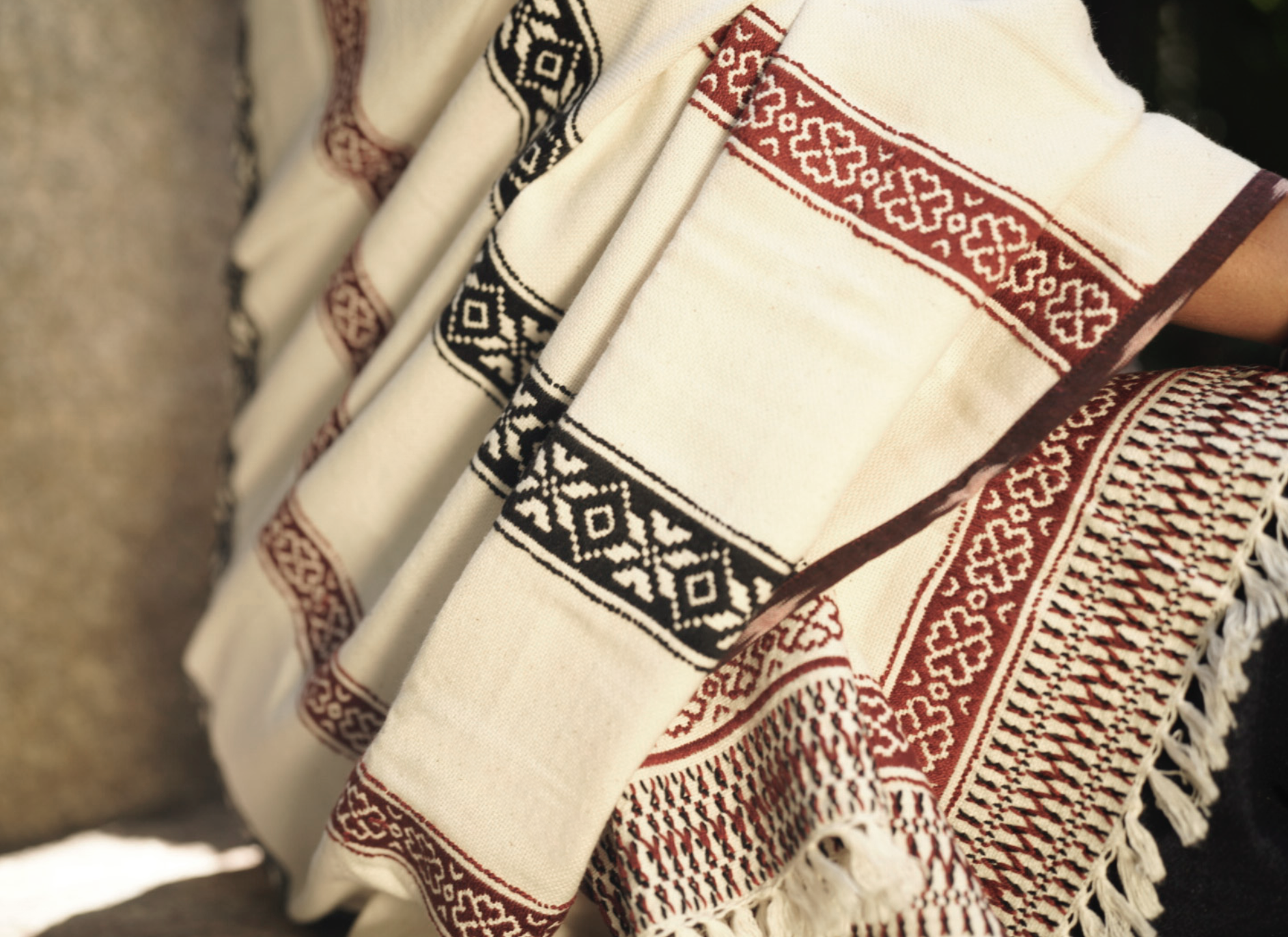 Full drape of Pukhoor shawl showing reversible embroidery and landscape motif borders
