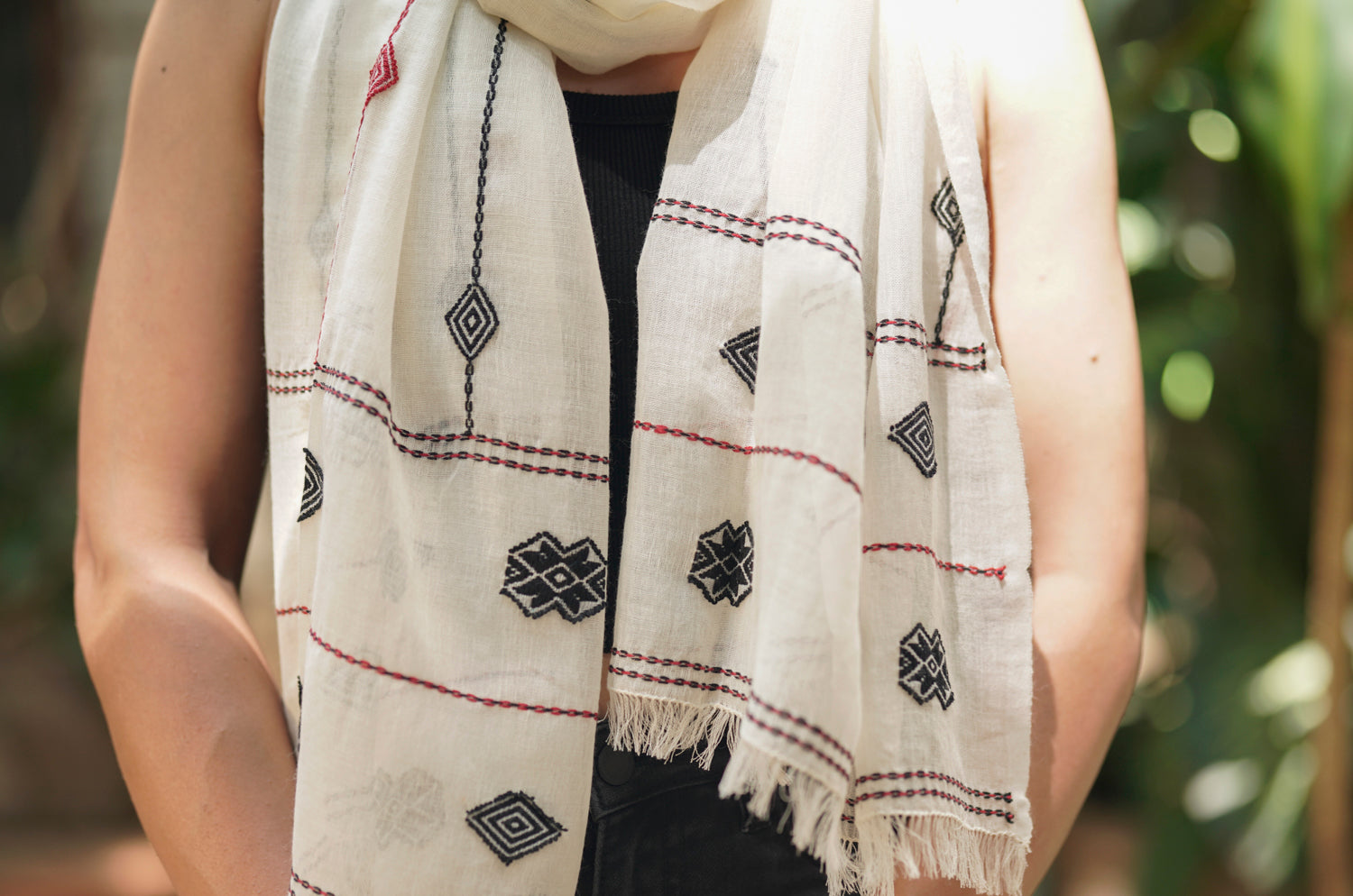 Close-up of diamond geometric Toda pukhoor embroidery at intersecting points on Merino cotton