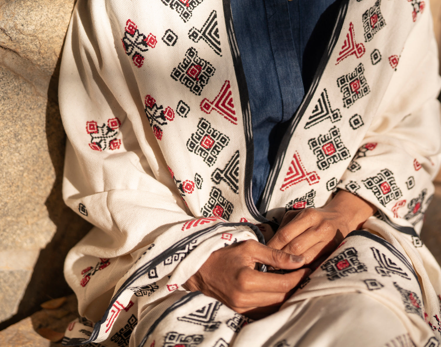 Detail of black and red Toda pukhoor botanical embroidery on Flora cotton shawl