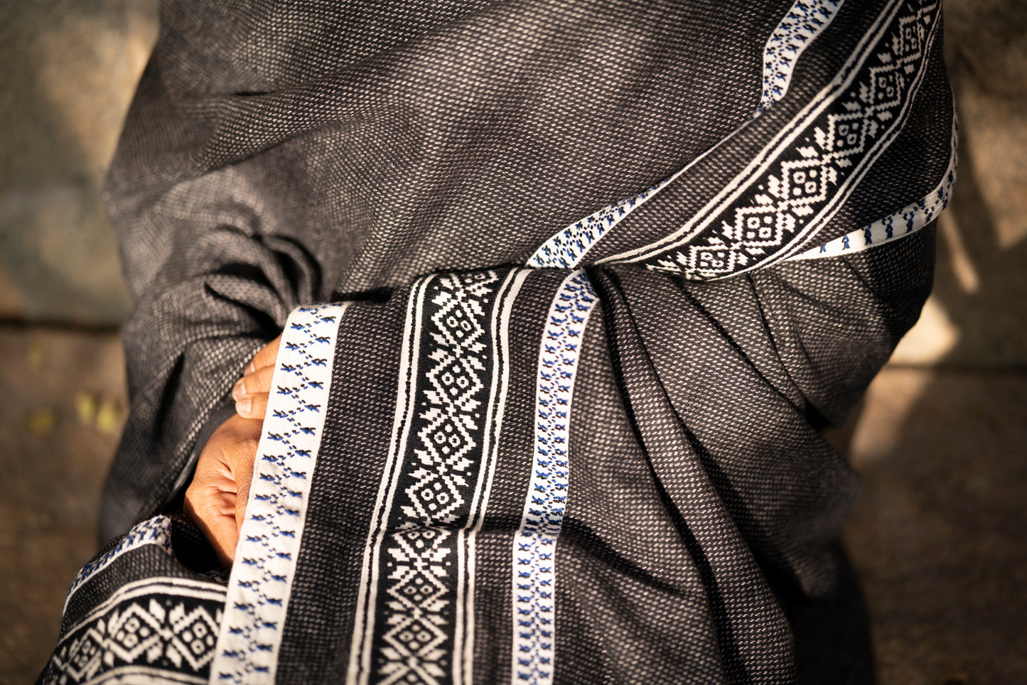 Detail of sun pattern Toda pukhoor embroidery in black and red on cotton-wool winter shawl