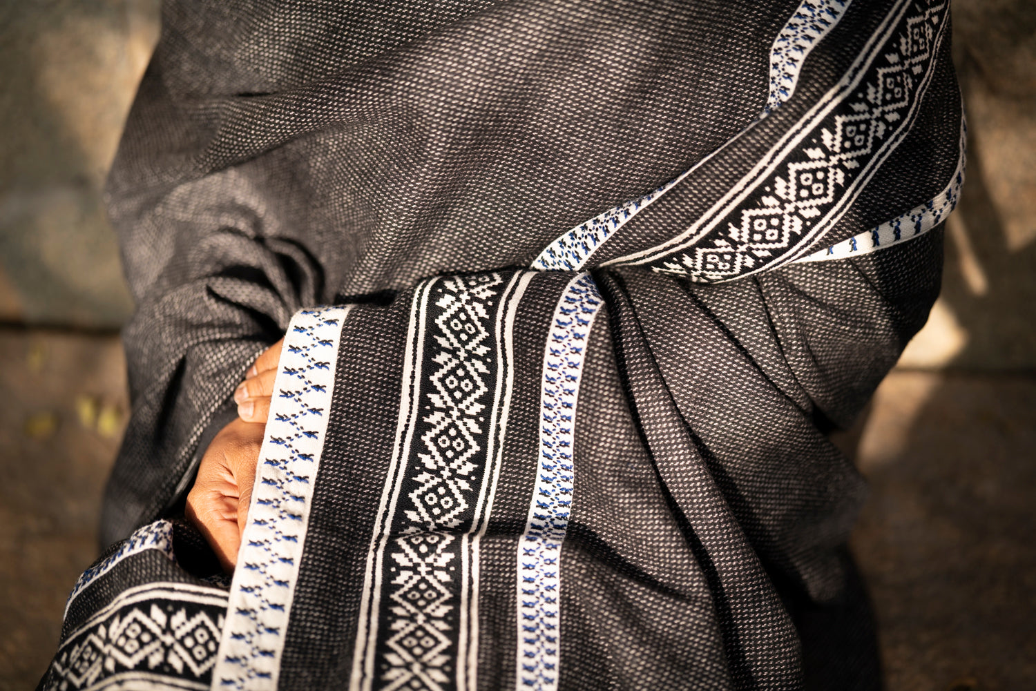 Detail of sun pattern Toda pukhoor embroidery in black and red on cotton-wool winter shawl
